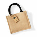 A jute tote bag from Westford Mill, model WM412, featuring black handles and a label that reads "Jute," is displayed against a white background.