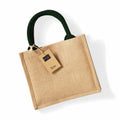 A beige jute tote bag featuring dark green handles and a brown tag labeled "Jute" is showcased. The product, WM412 by Westford Mill, is set against a plain white background, casting a soft shadow.