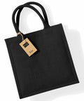 Black jute tote bag with two handles and a brown tag attached, Westford Mill WM413, against a white background.
