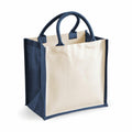 The WM421 tote bag by Westford Mill features a beige design with dark blue handles and edges. It is displayed standing upright on a white background.