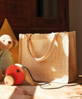 A Westford Mill WM431 sits on a wooden surface beside a toy bear and a wooden toy car in a sunlit room.