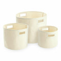Three cream-colored cylindrical fabric storage bins in different sizes, each featuring cutout handles, from Westford Mill's WM574 collection.
