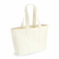 A Westford Mill WM610 tote bag, crafted from beige canvas with long handles and a rectangular shape, is positioned upright against a plain white background.