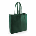 The Westford Mill WM623 green canvas tote bag, featuring two handles, stands upright against a plain white background.