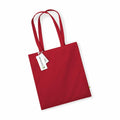 A cloth tote bag from Westford Mill, model WM801, is shown in red with long handles against a white background. A tag displaying text and symbols is attached to one handle.