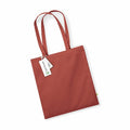 A plain brown tote bag from Westford Mill, model number WM801, features long handles, a small green tag on the side, and two white tags attached to one handle.