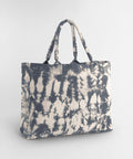 The Westford Mill tie-dye canvas tote bag, featuring two handles and a blue and white tie-dye pattern, is displayed on a plain light grey background.