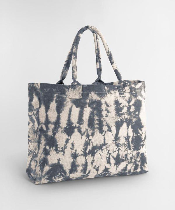 The Westford Mill tie-dye canvas tote bag, featuring two handles and a blue and white tie-dye pattern, is displayed on a plain light grey background.