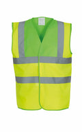 The Yoko YK001 is a sleeveless safety vest in bright yellow, featuring reflective silver stripes across the chest and shoulders for enhanced visibility. It has an open front and is displayed against a plain white background.