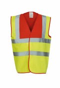 The Yoko YK001 is a high-visibility safety vest in fluorescent yellow and orange, featuring reflective silver stripes. It has a sleeveless design with an open front.