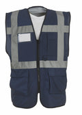 The Yoko YK002 is a dark blue safety vest featuring gray reflective stripes and a white label on the front, with multiple pockets and a zipper closure.