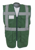 The Yoko YK002 safety vest is green with reflective gray stripes and multiple pockets, showcased against a plain background. It features a zip front and includes a white name badge area on the upper left side.