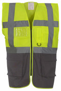 The Yoko YK002 is a high-visibility safety vest in bright yellow with gray reflective stripes. It includes multiple pockets and a front zipper, making it ideal for ensuring safety in workplaces such as construction or traffic management.