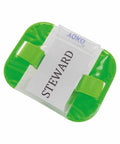 A Yoko YK202 badge holder with a transparent front displaying a card labeled "STEWARD" and a green elastic strap.