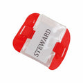 The Yoko YK202 features a red arm band with a transparent plastic pocket that displays a white card labeled STEWARD in black text. It includes adjustable red straps for securing it around the arm.
