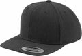 The Flexfit By Yupoong YP001 is a dark gray snapback cap, featuring a flat brim and a sticker on the visor, displayed from a side angle against a plain white background.