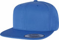 A vibrant blue Flexfit By Yupoong YP001 snapback cap featuring a flat brim with visible stitching. The front of the cap is plain, and there's a sticker on the brim confirming its authenticity as a snapback.