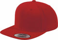 A red snapback cap featuring a flat brim and a sticker on the peak that reads "The Classics Snapback," from the Flexfit by Yupoong collection, product code YP001.