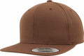 A brown YP001 snapback hat from Flexfit By Yupoong, featuring a flat brim with a "The Classics Yupoong Snapback" sticker. The design is minimalistic, lacking additional logos or embellishments.