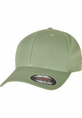 The YP004 baseball cap, produced by Flexfit By Yupoong, is displayed in a light green color against a white background. The curved visor features a round sticker that includes black and red text and logos.