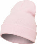 A YP012 light pink knitted beanie with a folded brim from Flexfit By Yupoong, isolated on a white background.