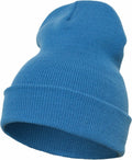 The YP012 beanie from Flexfit By Yupoong is presented at an angle, showcasing its blue knit fabric with a folded brim. The ribbed texture of the material is visible, giving the impression that this beanie is warm and cozy, ideal for cold weather.