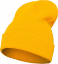 The Flexfit By Yupoong YP012 beanie hat, showcased in a vibrant yellow color, features a folded brim and has a knitted fabric appearance. It is displayed at an angle, highlighting its round and stretchy design.