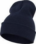 The Flexfit By Yupoong YP012 is showcased against a plain white background, featuring a dark blue knitted design with a folded cuff. The visible knit texture contributes to its cozy and warm look.