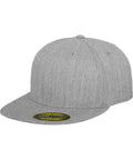 The YP017 from Flexfit By Yupoong is a gray snapback hat featuring a flat brim and round crown, made from subtly textured fabric. It also has a small black and yellow sticker on the brim.