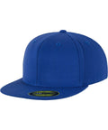 The YP017, a plain blue baseball cap with a flat brim from Flexfit By Yupoong, is displayed. Its brand-new condition is highlighted by the sticker on the brim. The cap features a simple design with six panels and small ventilation holes at the top of each panel.