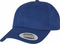 A simple, solid-colored blue baseball cap with a curved brim from Flexfit By Yupoong, featuring a circular sticker on the brim that reads "The Authentic Yupoong Since 1974, Adjustable." This is the YP022 model.