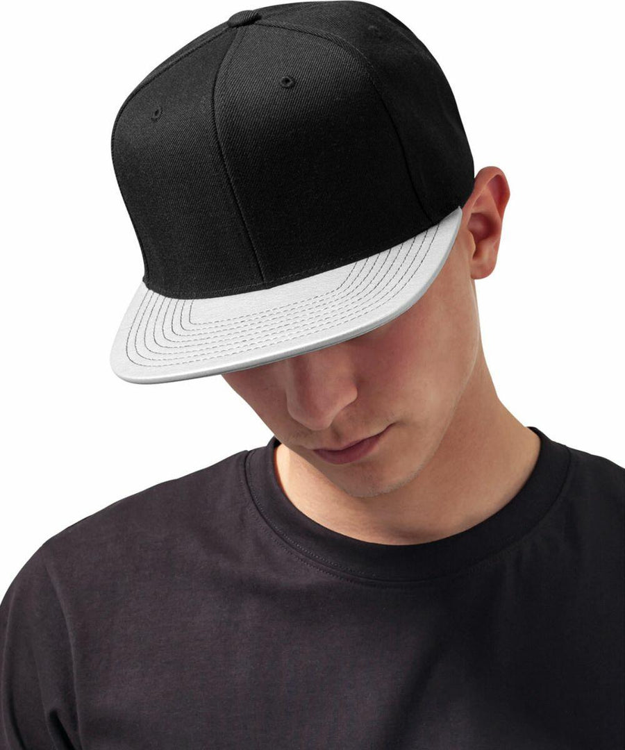 Person wearing a black T-shirt and a Flexfit By Yupoong YP024, looking down.