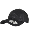 A black YP034 baseball cap from Flexfit By Yupoong, featuring a curved brim and a sticker on the front.