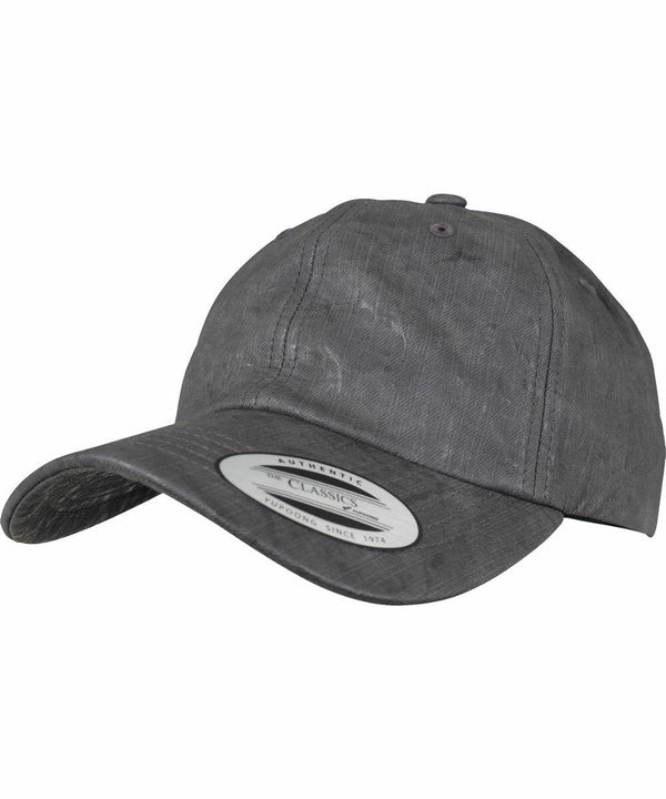 A dark gray baseball cap with a curved brim and a sticker on the front stating "YP034 Flexfit By Yupoong.