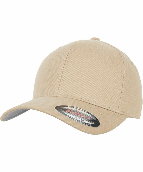 Beige baseball cap with a curved brim and a Flexfit By Yupoong YP045 sticker on the bill.