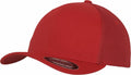 The YP051 by Flexfit By Yupoong is a red baseball cap featuring a solid front panel, a mesh back for enhanced ventilation, a curved brim, and a small sticker on the bill.