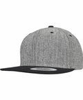 A Flexfit By Yupoong YP085 gray heather snapback hat with a black flat brim and a black button on top.