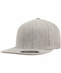 A grey, flat-brimmed baseball cap with a round crown and slightly textured fabric, shown angled to the left. The cap is the YP106 from Flexfit By Yupoong.