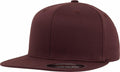 The YP106 baseball cap by Flexfit By Yupoong is a plain, dark brown hat with a flat brim, positioned to the left and featuring a sticker on the brim.