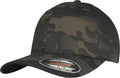 A dark camo-themed Flexfit By Yupoong cap, model YP112, featuring a curved brim with a sticker reading "The Original Flexfit, It Fits Your Life." This cap boasts a structured design and looks brand new.