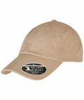A beige baseball cap with a curved brim and a black sticker on the front displaying "Flexfit By Yupoong YP172.