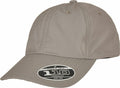 A beige baseball cap with a curved brim features a sticker on the front that says "Flexfit Tech 110 One Ten," and it's part of the Flexfit By Yupoong's YP184 collection.