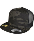 A Flexfit By Yupoong YP210 snapback hat featuring a camouflage pattern, black mesh back, and a sticker on the front brim.