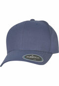 The YP217 cap from Flexfit By Yupoong is shown at an angle, showcasing its plain, dark blue design with a curved brim. A Flexfit sticker on the brim indicates it is size L/XL, and the cap offers a minimalist look without logos or decorations.