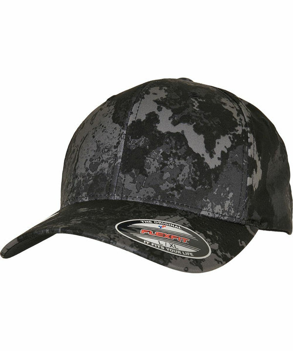 A black and gray camouflage-patterned baseball cap with a flat bill and an adhesive label on the front, the Flexfit By Yupoong YP224.