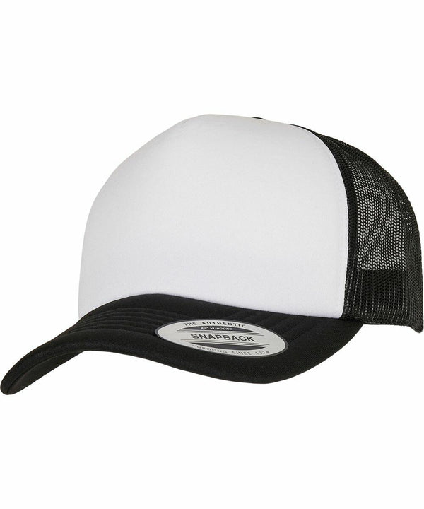 A black and white YP227 snapback trucker hat with a mesh back and a sticker labeled "Flexfit By Yupoong" on the brim.