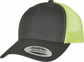 A YP237 trucker cap from Flexfit By Yupoong is displayed at an angle. It has black front panels and brim, while the back features a neon yellow mesh. A sticker on the brim reads "Snapback, Yupoong since 1974.