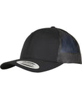 The Flexfit by Yupoong Trucker recycled polyester fabric cap (6606TR) features a black design, curved brim, mesh back panels, and a snapback sticker. It’s angled against a white background.