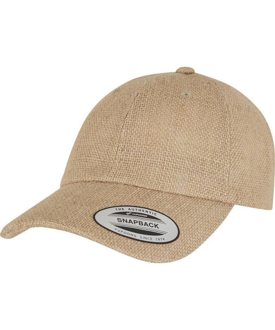The Flexfit Dad jute cap (9303) by Flexfit by Yupoong is a beige textured baseball cap with a curved peak and a "Snapback" sticker on the front of the peak, shown unworn against a white background.