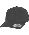 The Flexfit retro reflective cap (9310) by Flexfit by Yupoong is a plain black cap with a curved peak and a sticker on the bill reading "The Authentic Adjustable Yupoong Since 1974," displayed on a white background.